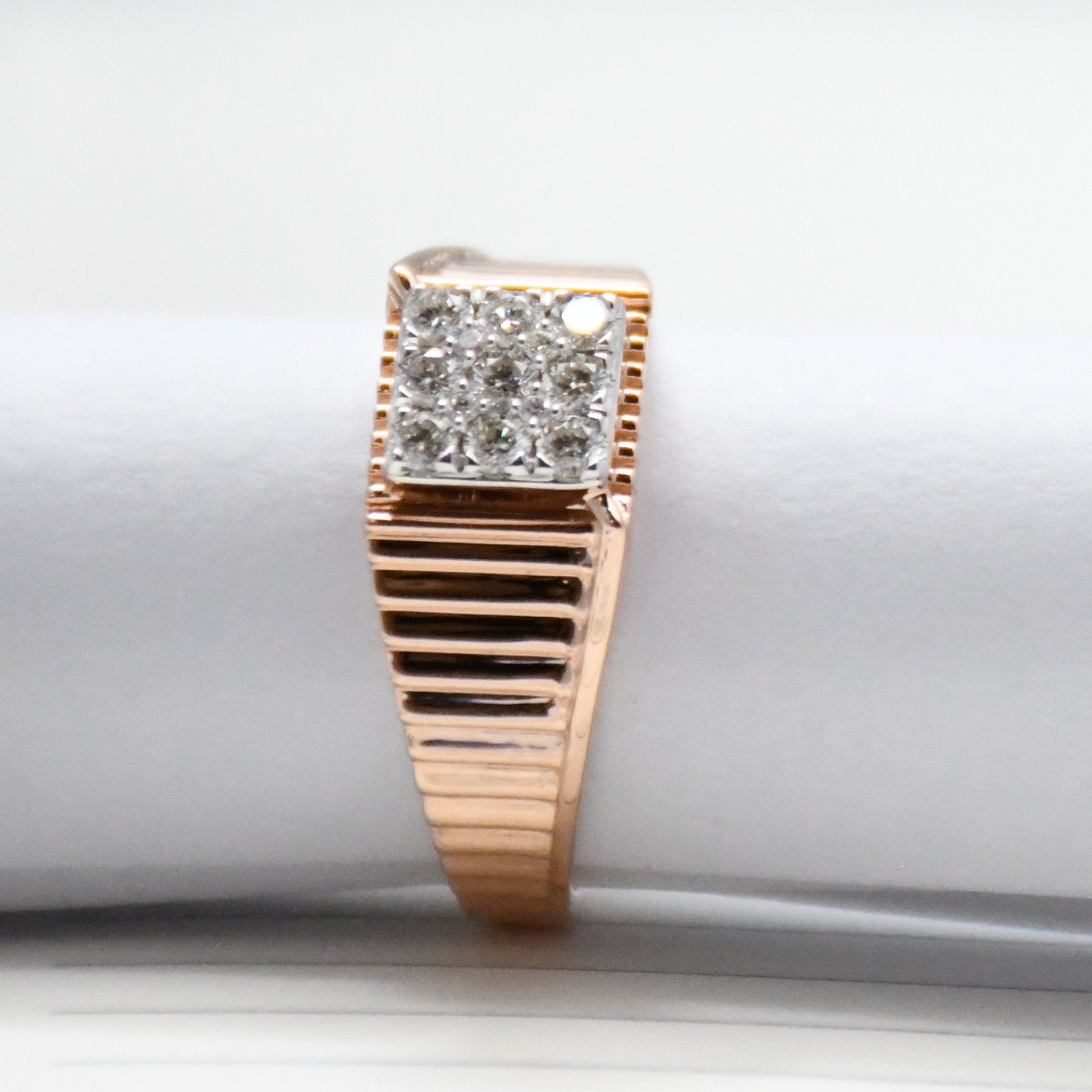 gold ring with diamond accents on a white surface