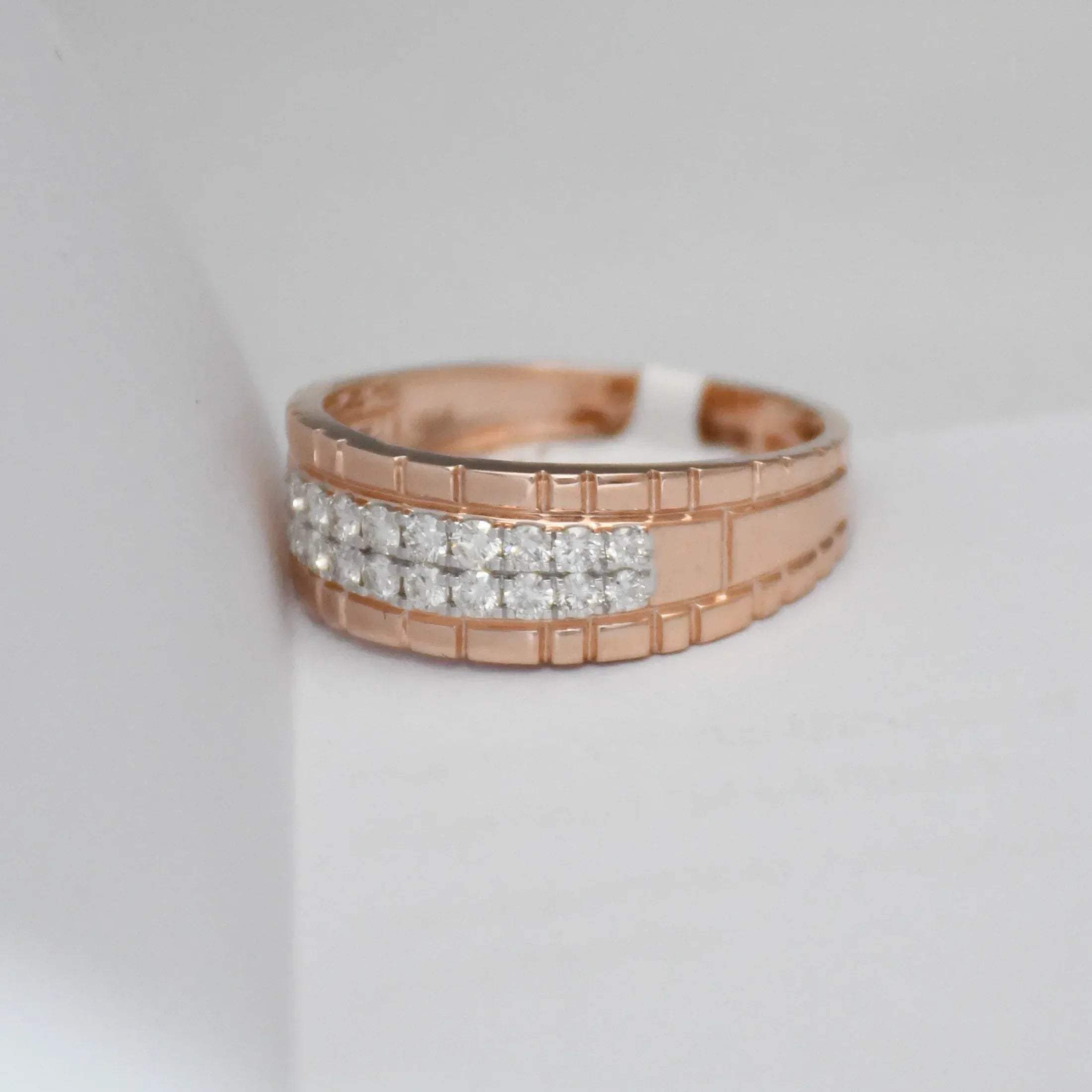 gold ring with diamond accents on a light gray background