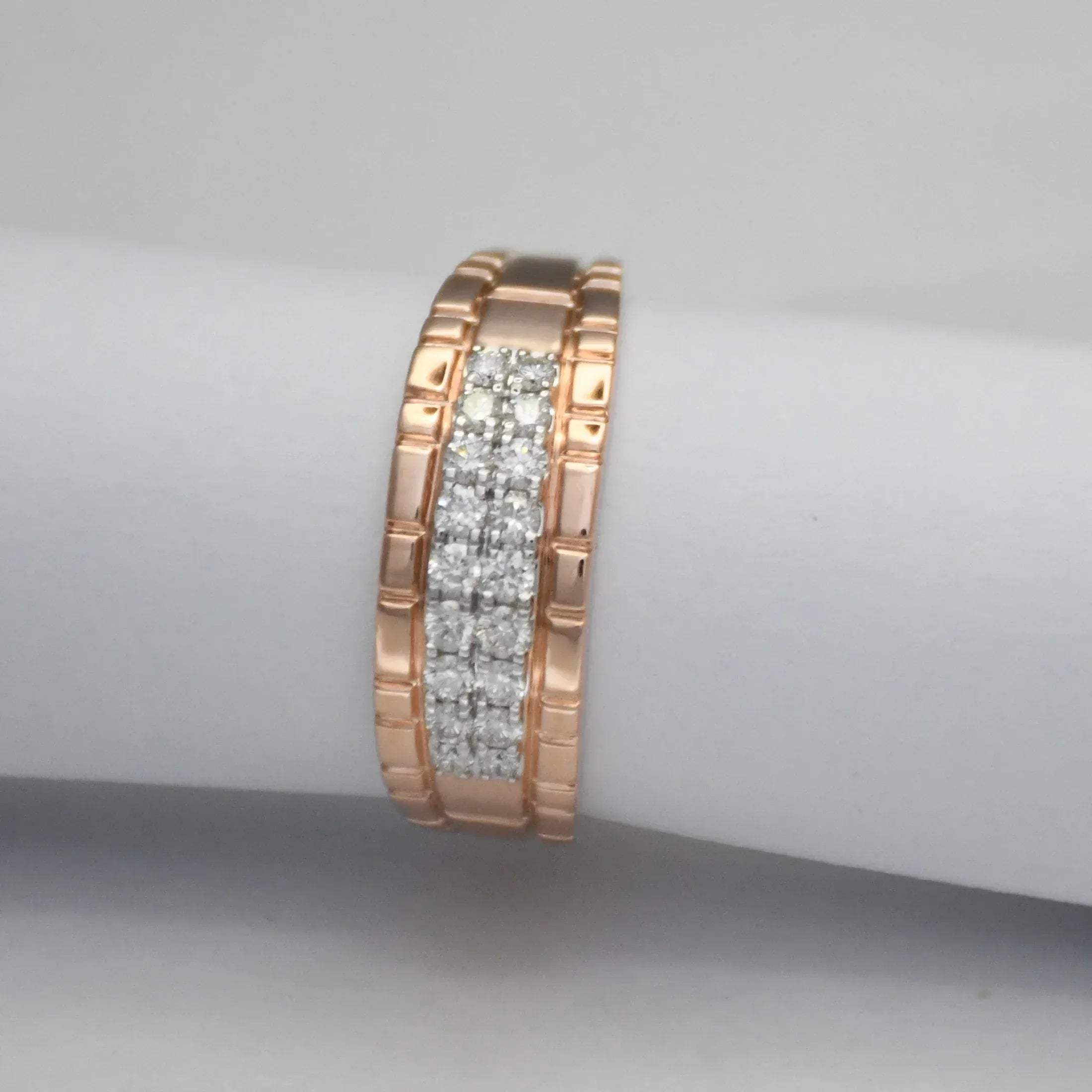 gold ring with embedded diamonds on a gray background