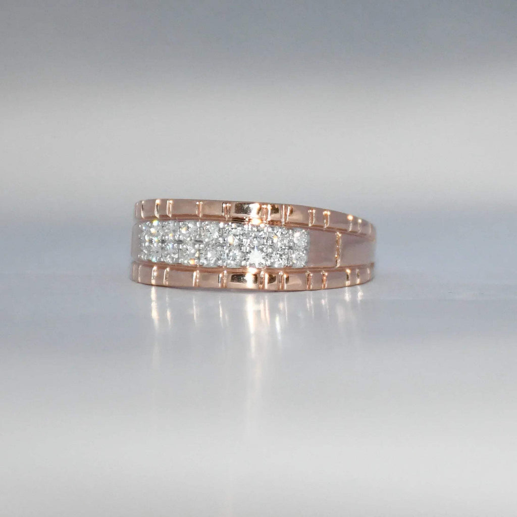 gold ring with embedded diamonds on a reflective surface