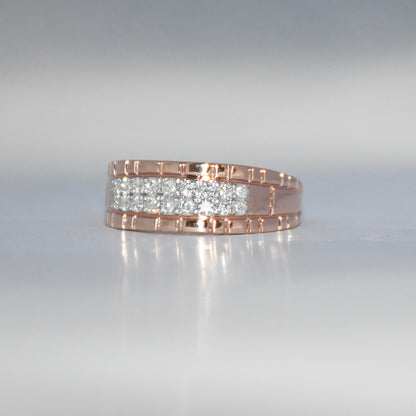 gold ring with embedded diamonds on a reflective surface