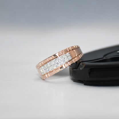 gold ring with diamonds on a black stand against a gray background