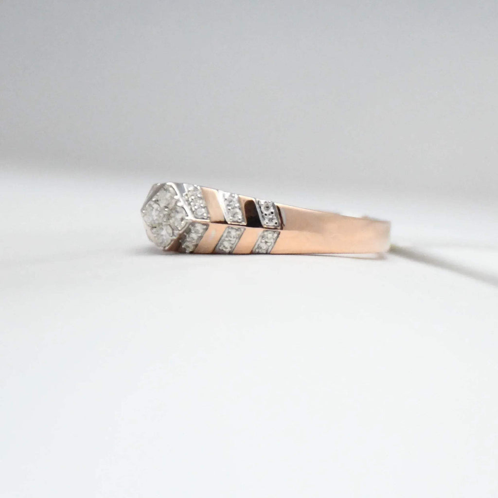 gold ring with diamond accents on a light gray background