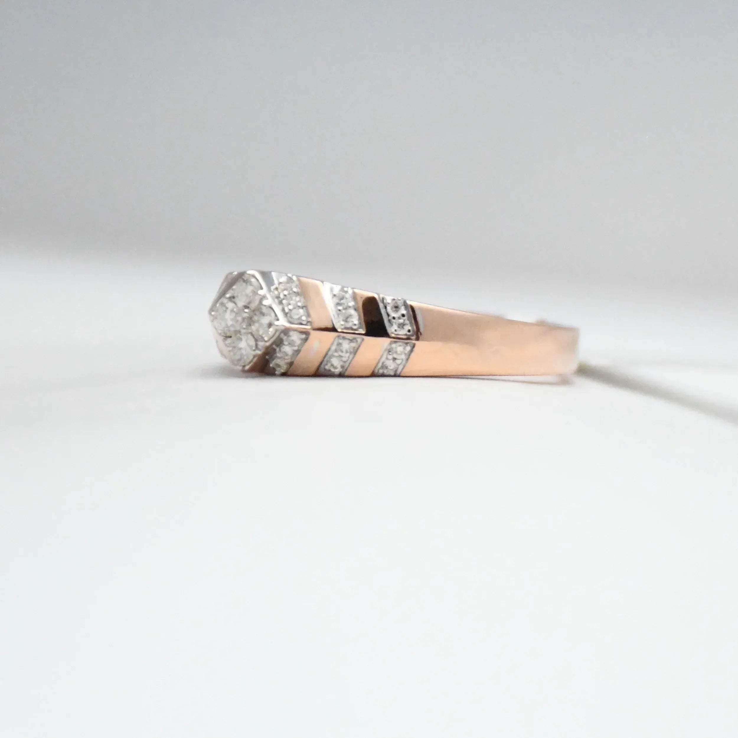 gold ring with diamond accents on a light gray background