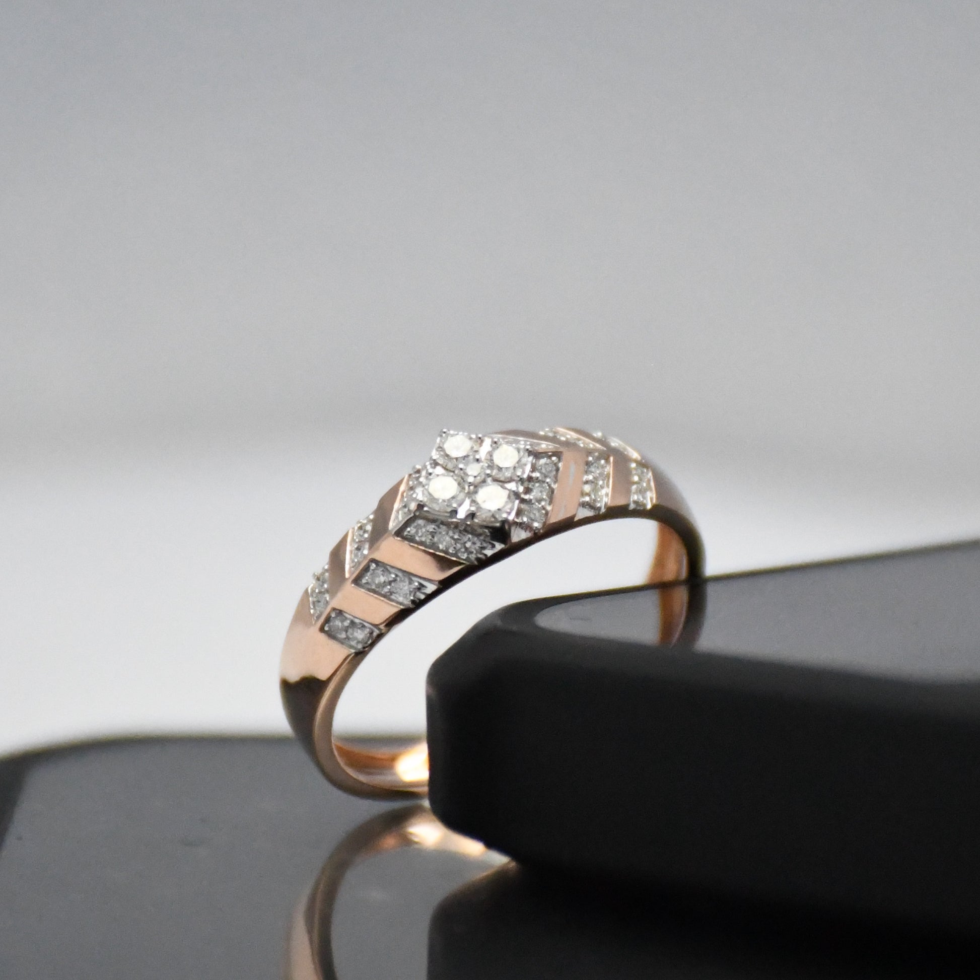 gold ring with diamonds on a reflective surface