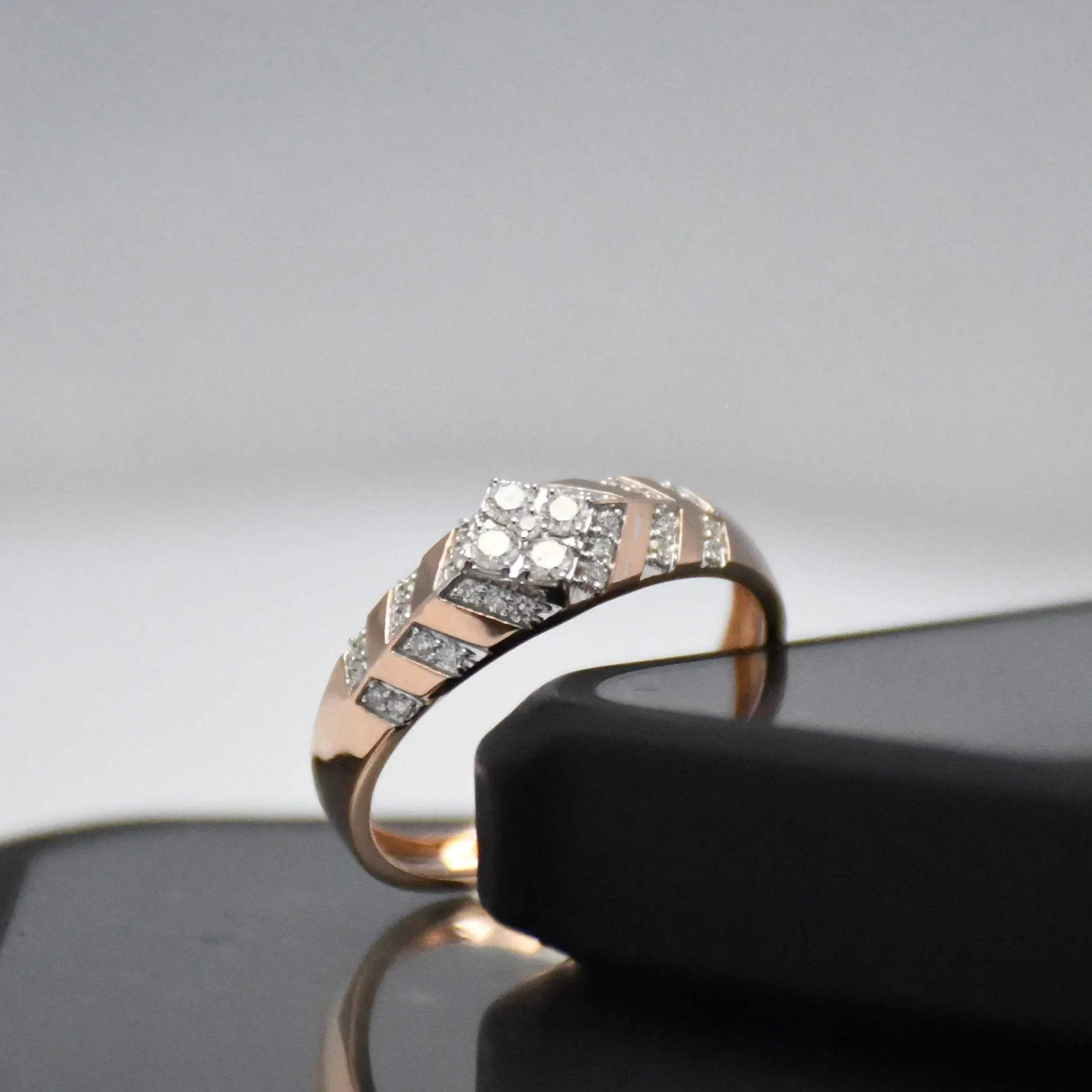 gold ring with diamonds on a reflective surface