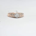 gold ring with diamond accents on a light gray background
