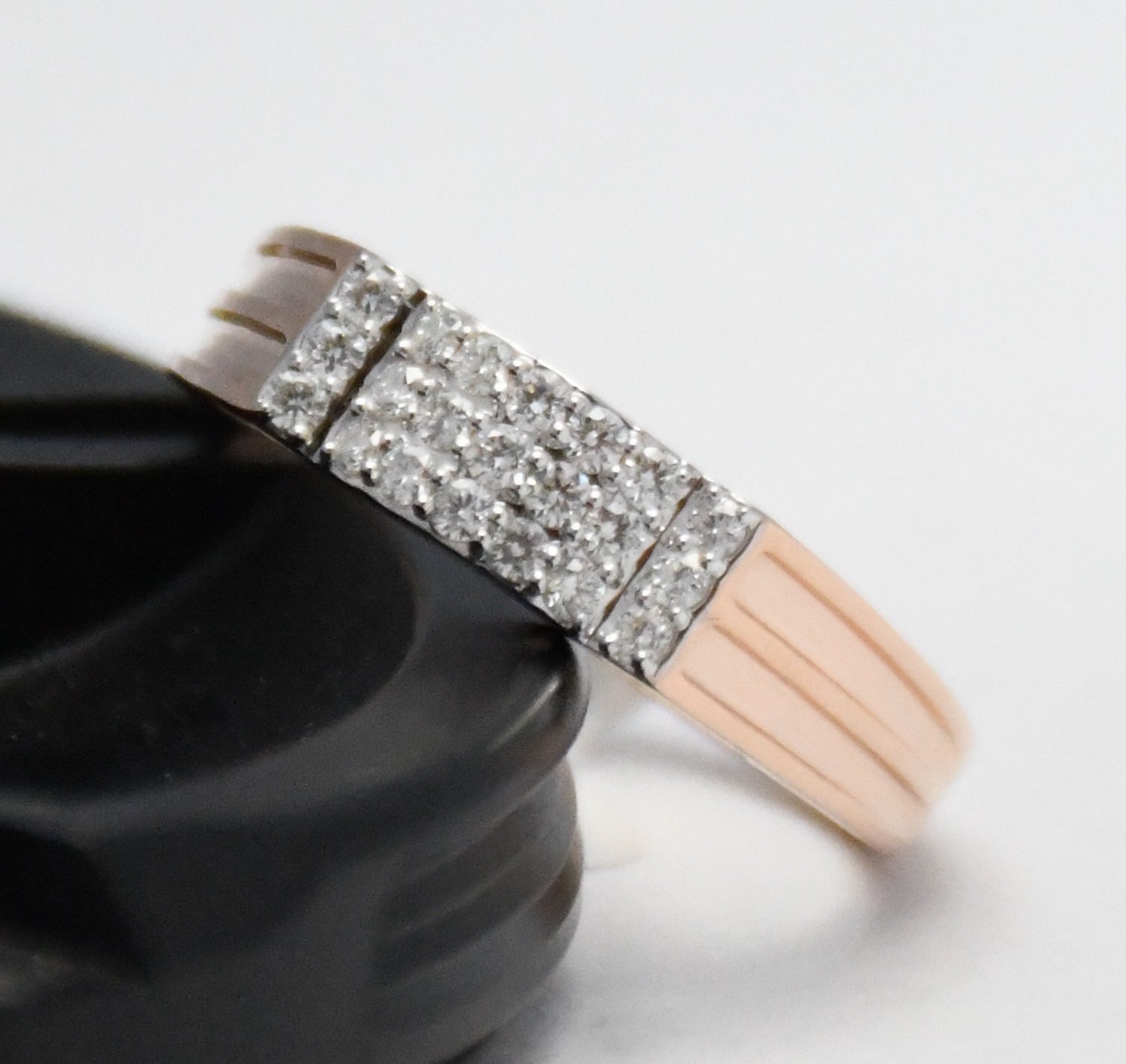 men's diamond ring with glittery gold band on a white background