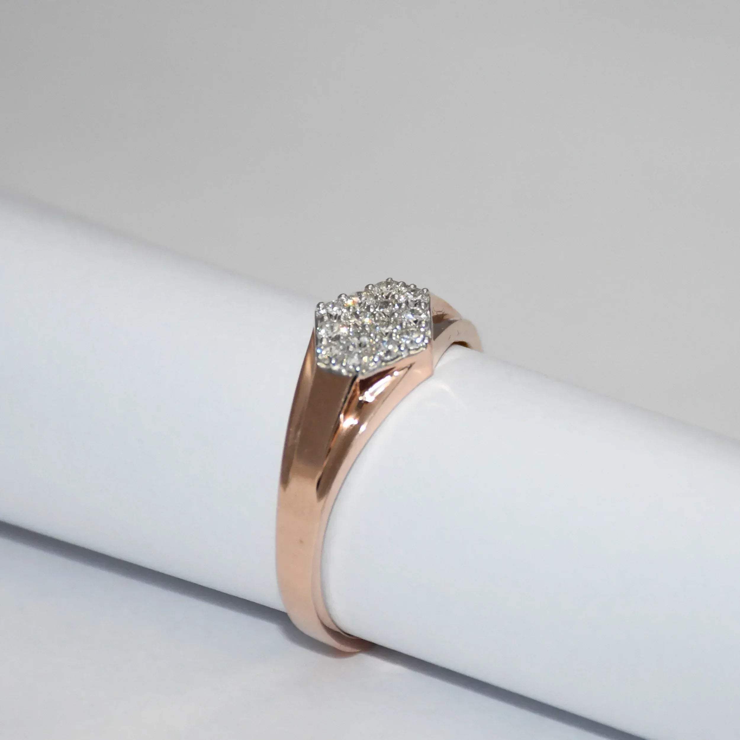 gold ring with a diamonds cluster on a white surface