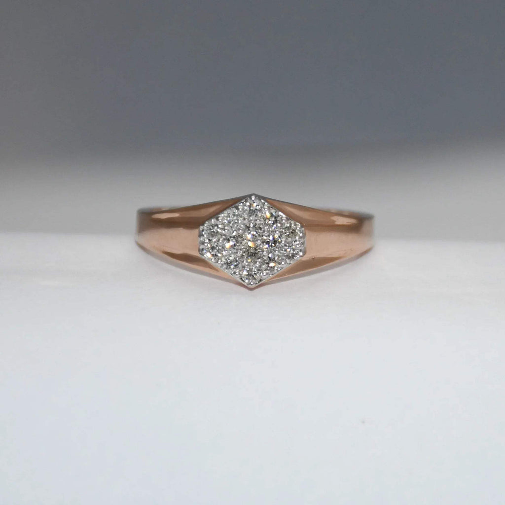 gold ring with diamond center on a gray background