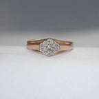 gold ring with diamond center on a gray background
