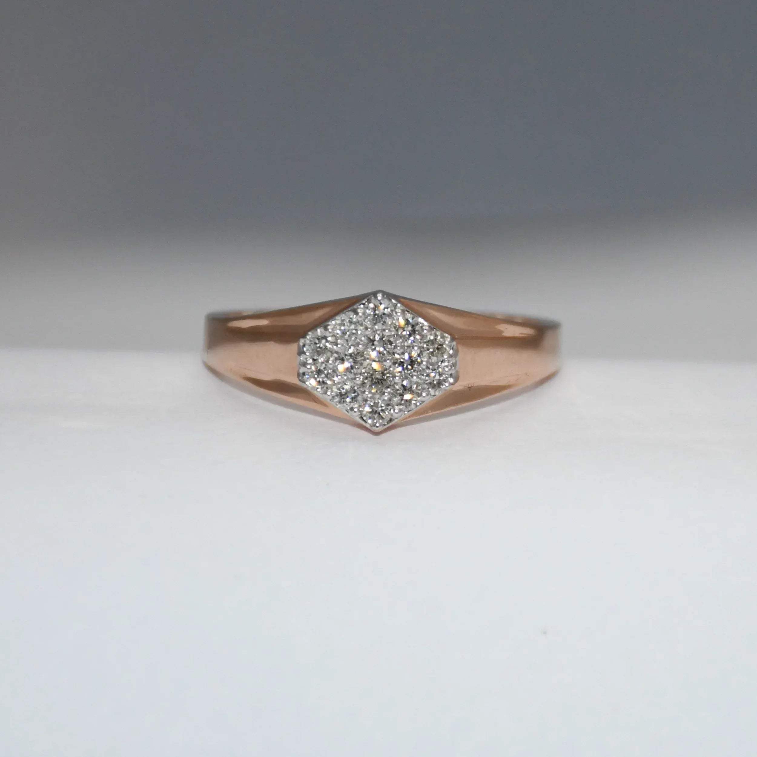 gold ring with diamond center on a gray background