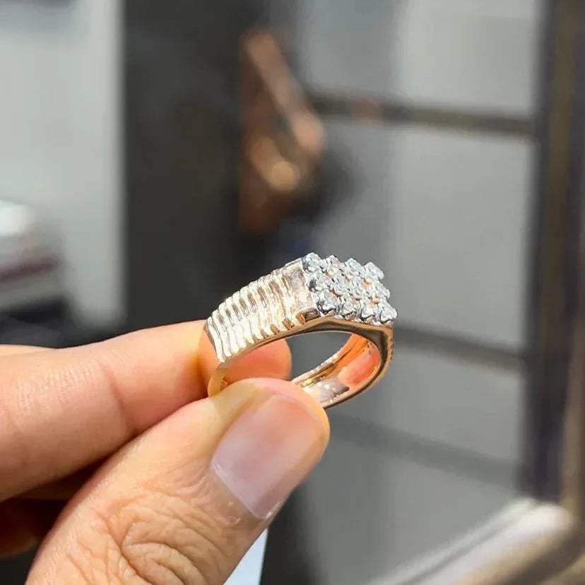 A man's hand displaying a cluster set diamonds ring made in gold.