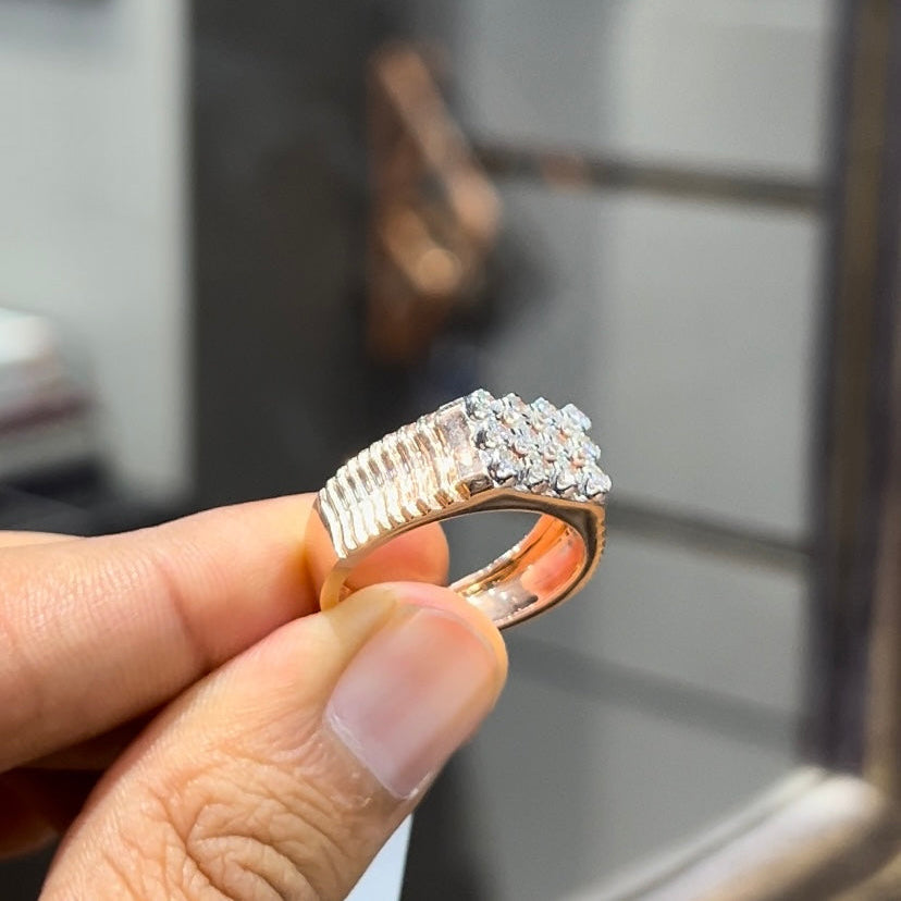A man's hand displaying a cluster set diamonds ring made in gold.