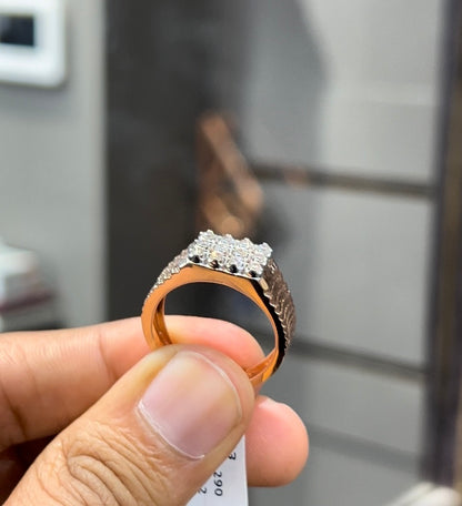 A man's hand displaying a cluster set diamonds ring made in gold.