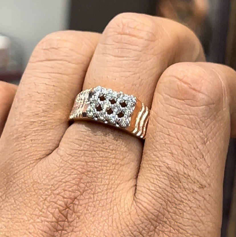 A man's hand displaying a cluster set diamonds ring made in gold.