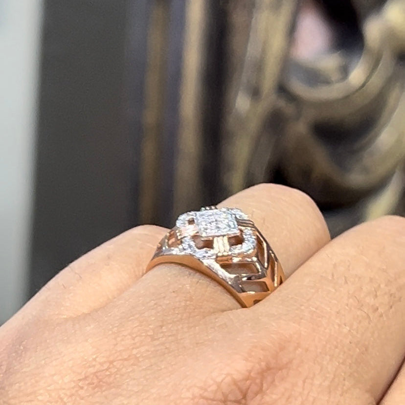A man's hand displaying a gold band ring with diamonds cluster in the center.