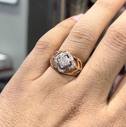 A man's hand displaying a gold band ring with diamonds cluster in the center.