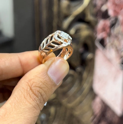 A man's hand displaying a gold band ring with diamonds cluster in the center.