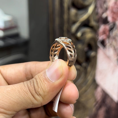 A man's hand displaying a gold band ring with diamonds cluster in the center.