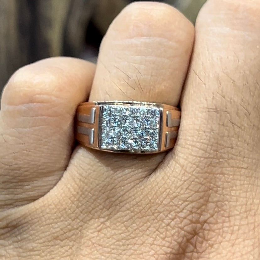 A man's hand displaying a diamond ring with a gold band.