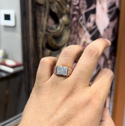 A man's hand displaying a diamond ring with a gold band.