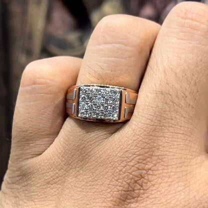A man's hand displaying a diamond ring with a gold band.