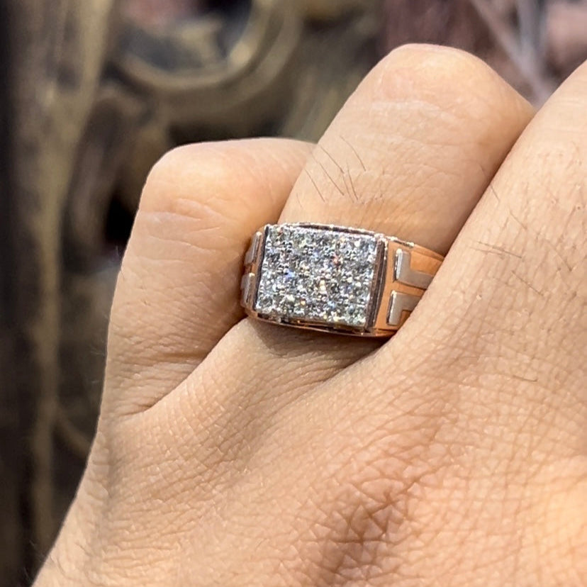 A man's hand displaying a diamond ring with a gold band.