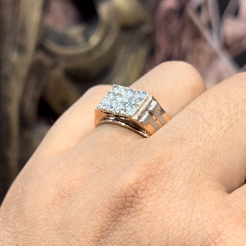 A man's hand displaying a diamond ring with a gold band.