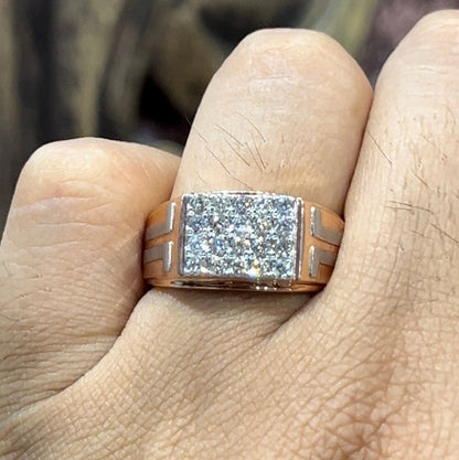 A man's hand displaying a diamond ring with a gold band.