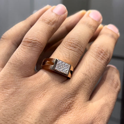 A man's hand displaying a diamond ring with a gold band.