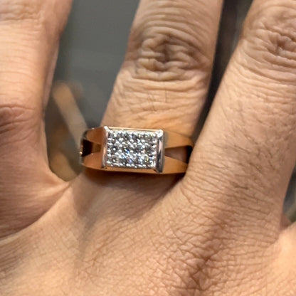 A man's hand displaying a diamond ring with a gold band.