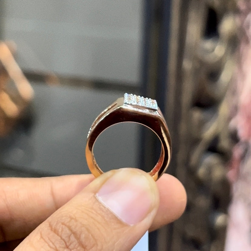 A man's hand displaying a diamond ring with a gold band.