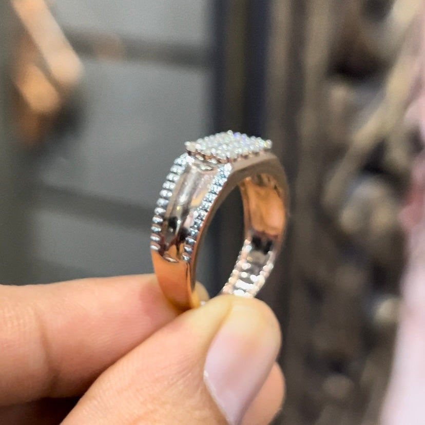 A man's hand displaying a gold band with a large diamond ring.