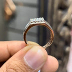 A man's hand displaying a gold band with a large diamond ring.