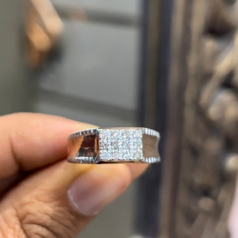 A man's hand displaying a gold band with a large diamond ring.