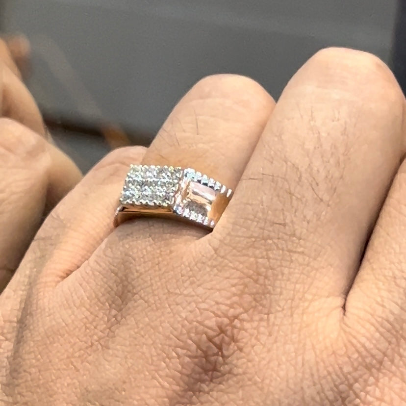 A man's hand displaying a gold band with a large diamond ring on his finger.