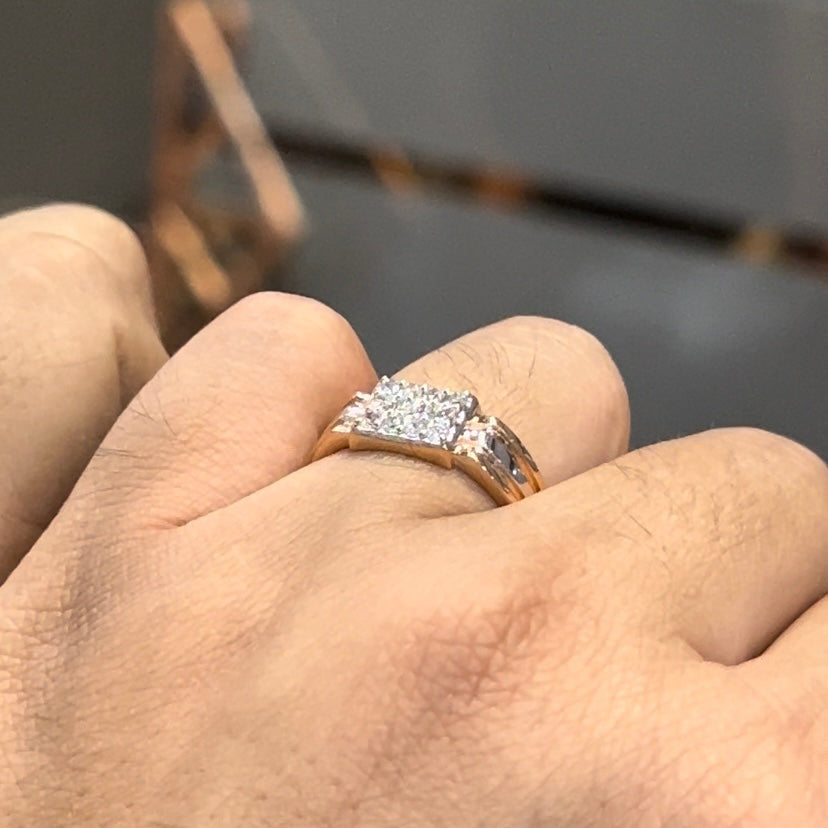 Men’s diamond ring in dual-tone gold with bold rectangular cluster of round diamonds at the center, flanked by sleek metal panels, shown worn on finger.