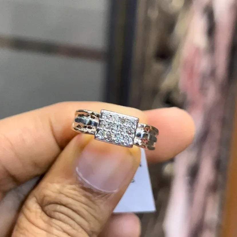 Close-up of gents diamond ring featuring rectangular diamond cluster centerpiece in rose and white gold band, reflecting strong masculine design.