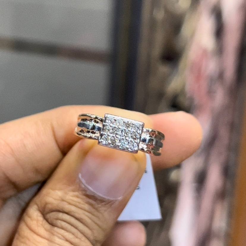 Close-up of gents diamond ring featuring rectangular diamond cluster centerpiece in rose and white gold band, reflecting strong masculine design.