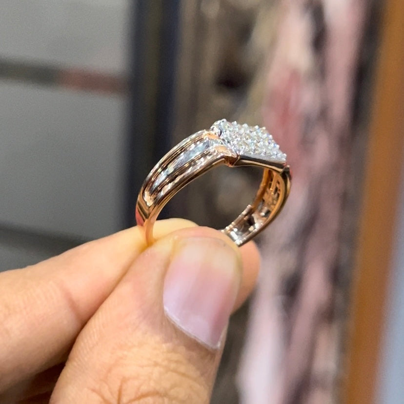 Close-up of gents diamond ring featuring rectangular diamond cluster centerpiece in rose and white gold band, reflecting strong masculine design.