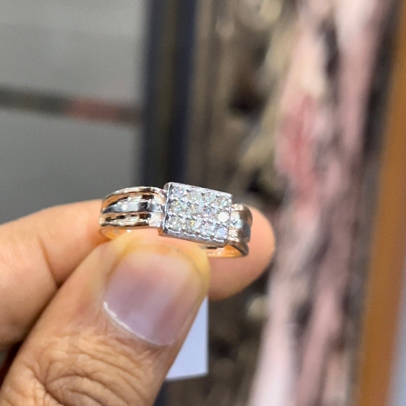 Close-up of gents diamond ring featuring rectangular diamond cluster centerpiece in rose and white gold band, reflecting strong masculine design.