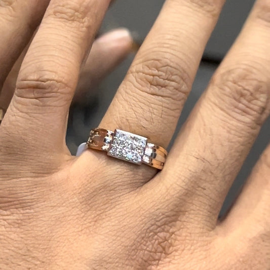 Men’s diamond ring in dual-tone gold with bold rectangular cluster of round diamonds at the center, flanked by sleek metal panels, shown worn on finger.