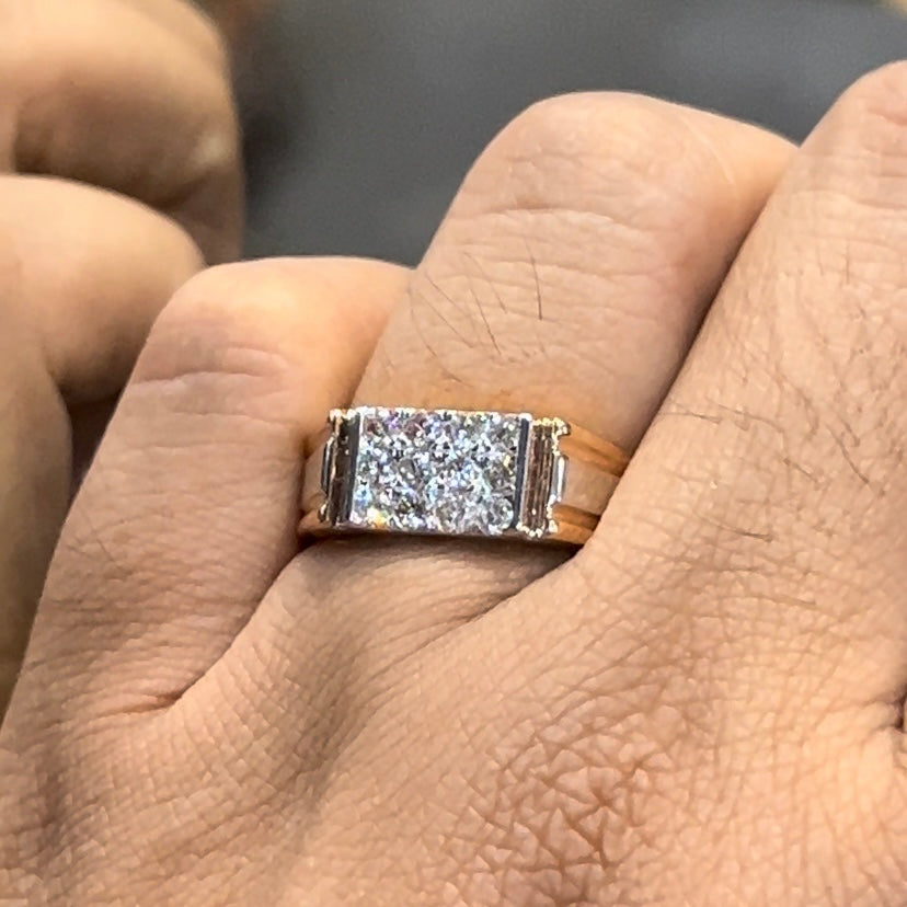 Men’s diamond ring in dual-tone gold with bold rectangular cluster of round diamonds at the center, flanked by sleek metal panels, shown worn on finger.
