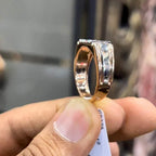 Men’s diamond ring in dual-tone gold with bold rectangular cluster of round diamonds at the center, flanked by sleek metal panels, shown worn on finger.