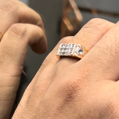 Men’s diamond ring in dual-tone gold with bold rectangular cluster of round diamonds at the center, flanked by sleek metal panels, shown worn on finger.