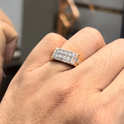 Men’s diamond ring in dual-tone gold with bold rectangular cluster of round diamonds at the center, flanked by sleek metal panels, shown worn on finger.