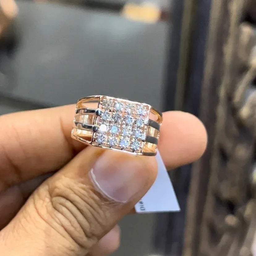 A man's hand holding a diamond ring with a solid gold band, featuring a clear diamond centerpiece.