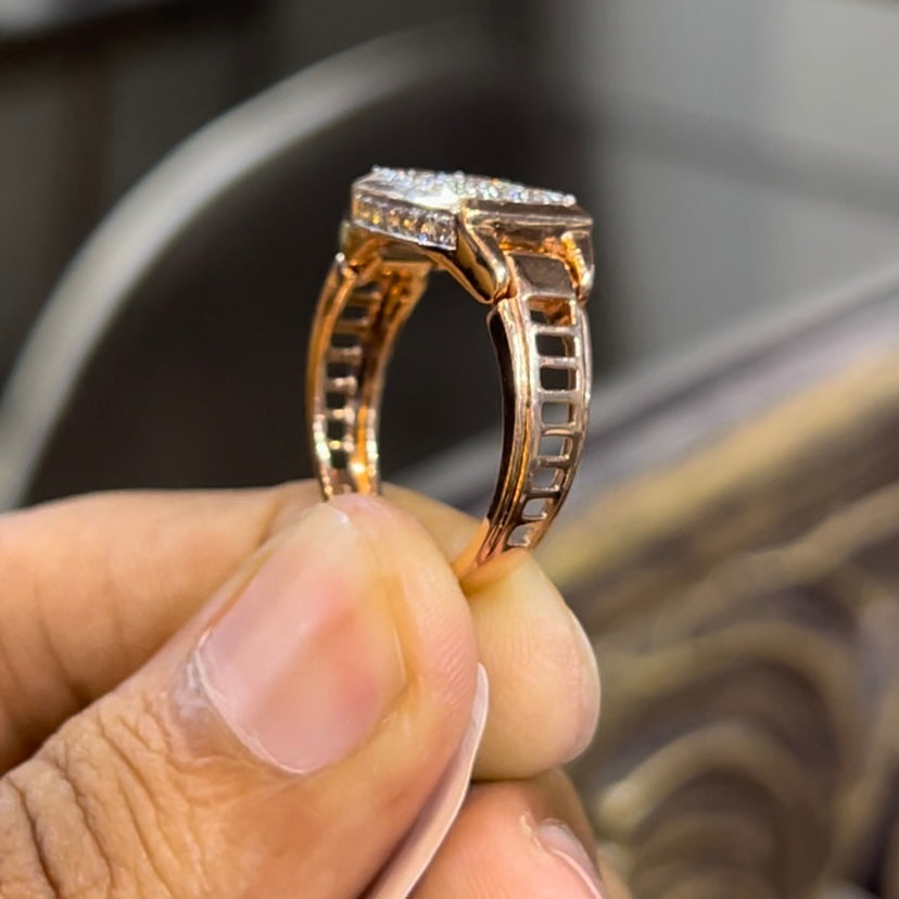 A man's hand holding a diamond ring with a solid gold band, featuring a prominent smaller diamonds along the band.