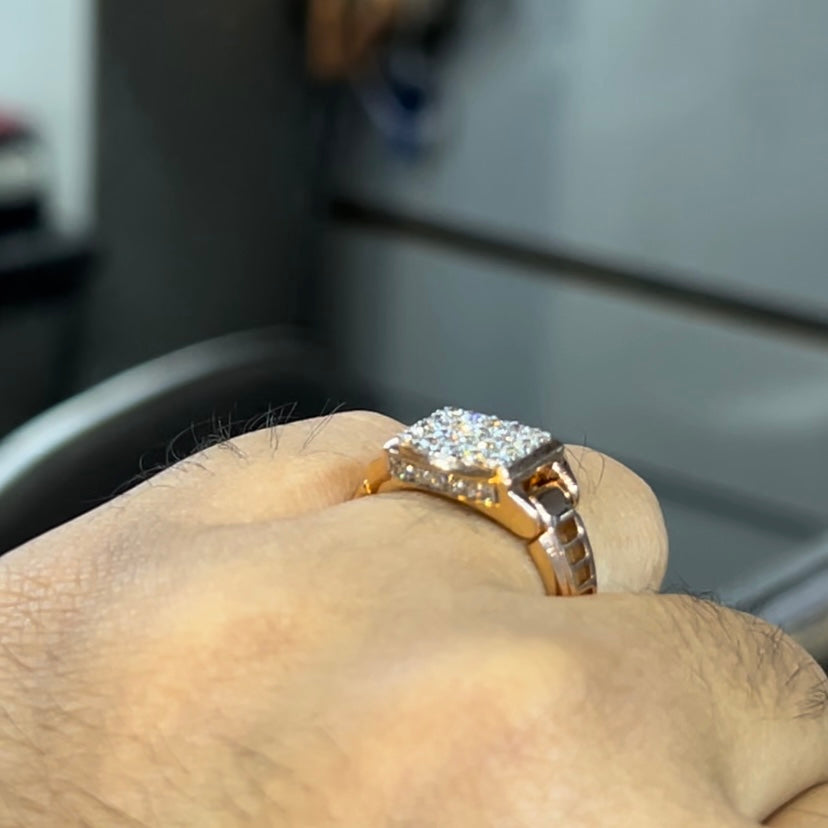 A man's hand holding a diamond ring with a solid gold band, featuring a prominent smaller diamonds along the band.